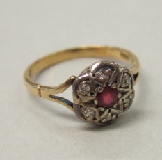 Appraisal: A gold ruby and diamond set cluster ring the ruby