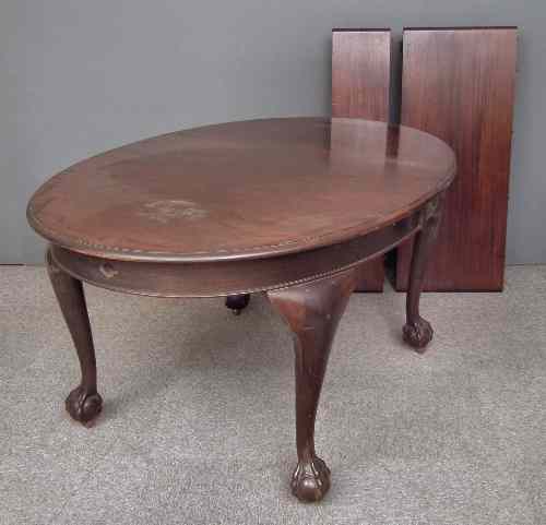 Appraisal: A s mahogany oval extending dining table with two extra