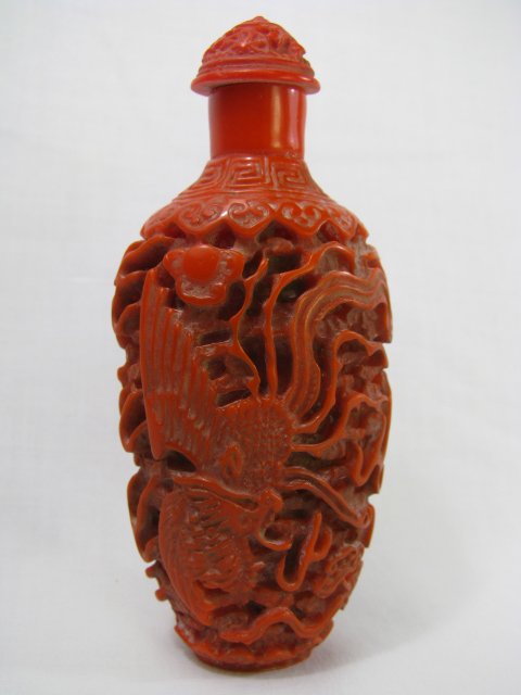 Appraisal: Carved cinnabar snuff bottle with a dragon and large bird