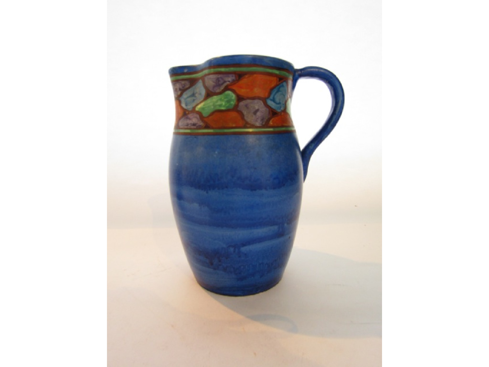 Appraisal: A Blue ground Art Deco jug with painted border decoration