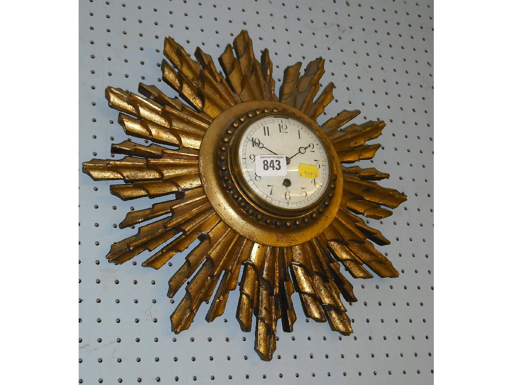 Appraisal: French giltwood sunburst clock the white dial within a beaded