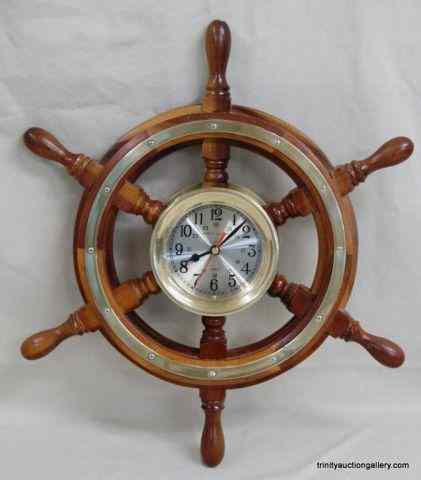 Appraisal: Brass Ships Clock Mounted in Ships WheelThis is a very