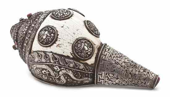 Appraisal: A Tibetan Silver Repousse Mounted Conch Shell the shell mounted