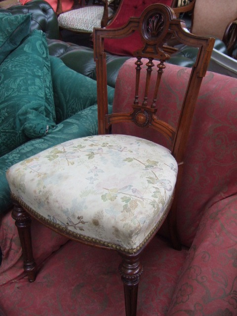 Appraisal: A pair of Victorian walnut framed occasional chairs with shaped