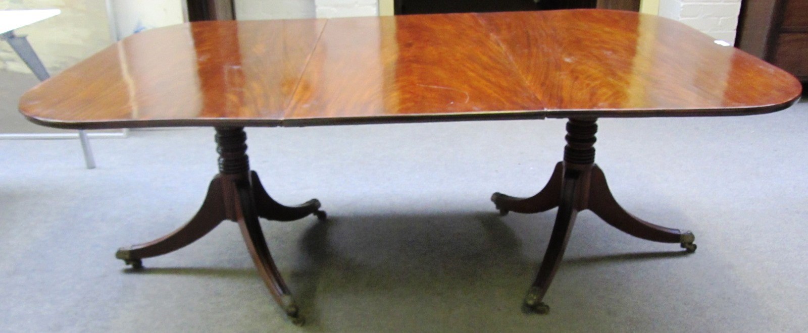 Appraisal: A George III mahogany twin pedestal dining table one extra