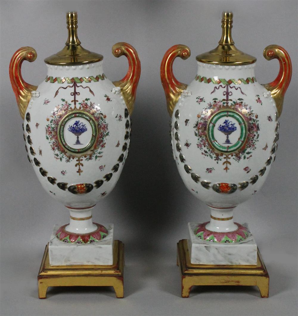 Appraisal: PAIR OF CHINESE EXPORT FAMILLE ROSE DECORATED PISTOL-HANDLED URNS TH