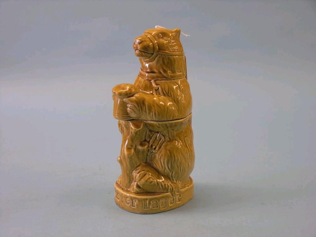 Appraisal: An unusual advertising table lighter Hofmeister earthenware bear enclosing Hofmeister