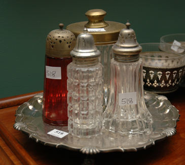 Appraisal: A VICTORIAN RUBY GLASS CASTER With two Victorian cruet bottles