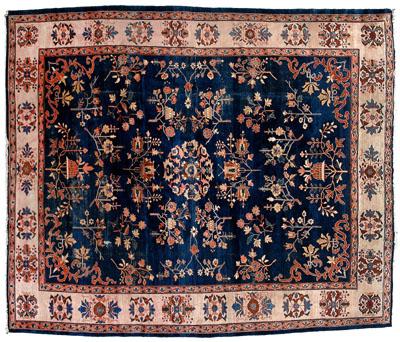 Appraisal: Sarouk rug repeating floral designs on dark blue ground some