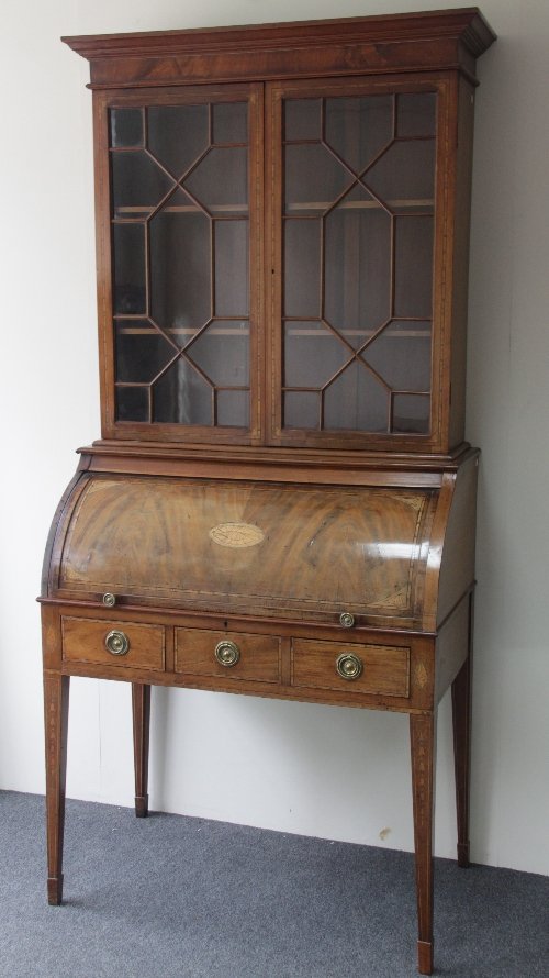 Appraisal: A mahogany roll top bureau bookcase circa with astragal glazed