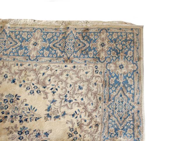 Appraisal: A cream ground carpet within blue borders overall decorated with