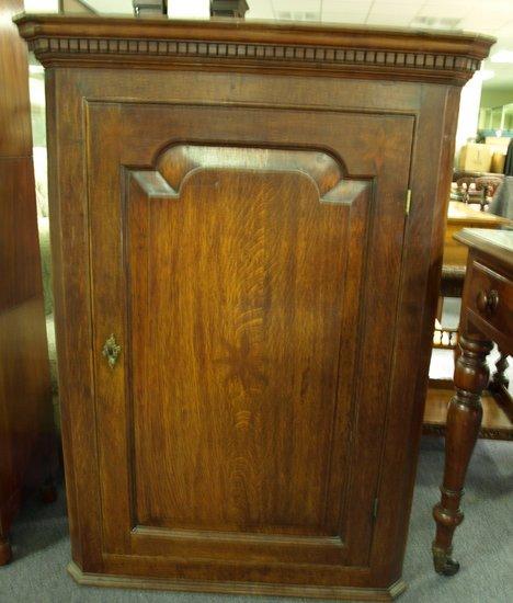 Appraisal: An early th Century oak corner cupboard with dentil cornice