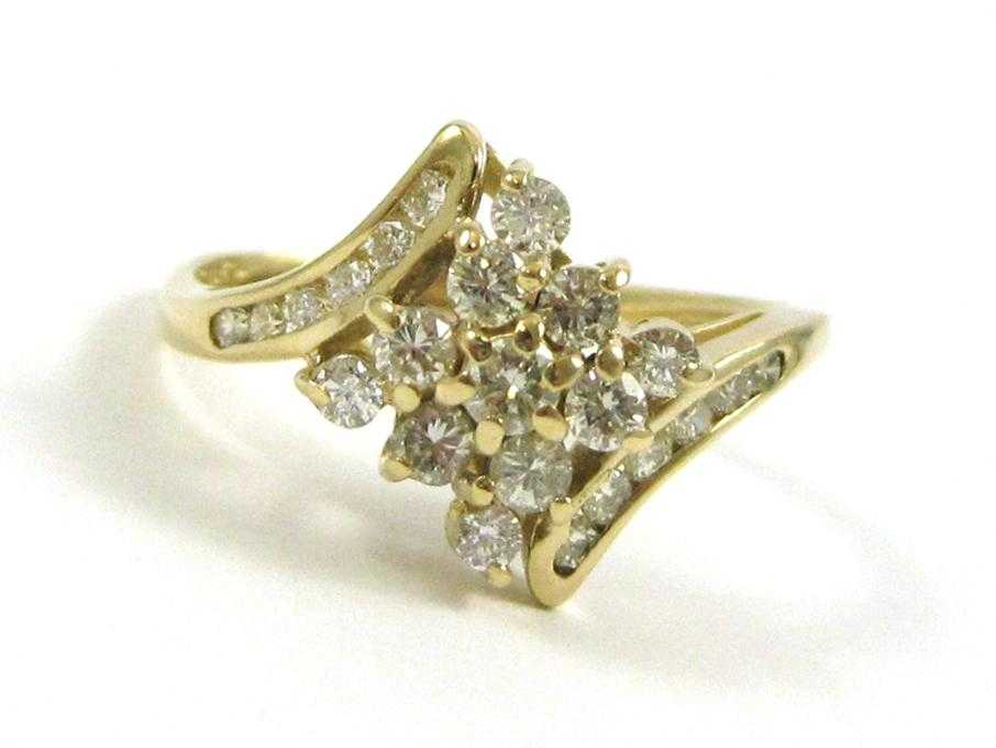 Appraisal: DIAMOND AND FOURTEEN KARAT GOLD CLUSTER RING set with round-cut