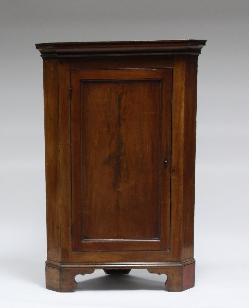 Appraisal: An th Century fruitwood corner cupboard with panelled doors cm