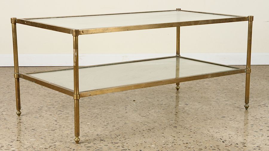 Appraisal: TIERED BRASS GLASS COFFEE TABLE A two tiered brass and