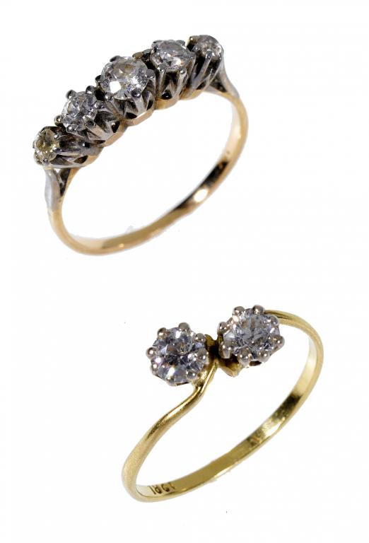 Appraisal: A DIAMOND FIVE-STONE RING AND A DIAMOND CROSS-OVER RING gold