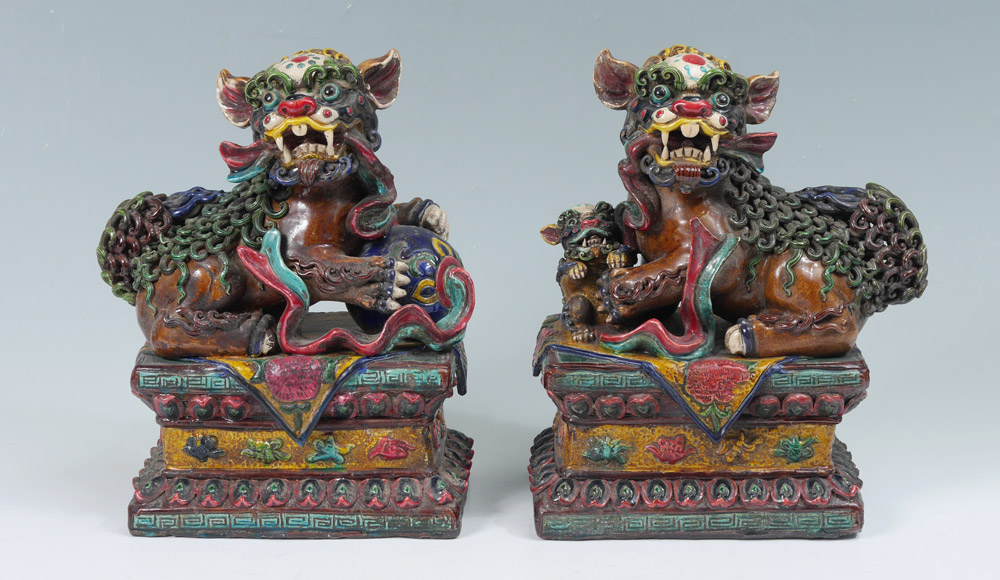 Appraisal: PAIR POLYCHROME FOO DOGS A most dramatic depiction of male