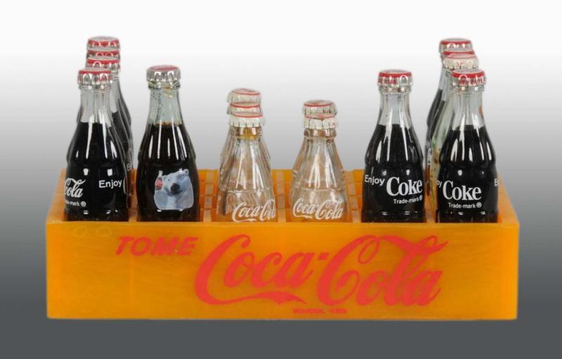 Appraisal: Plastic Coca-Cola Spanish -Bottle Miniature Case Description s Various bottles