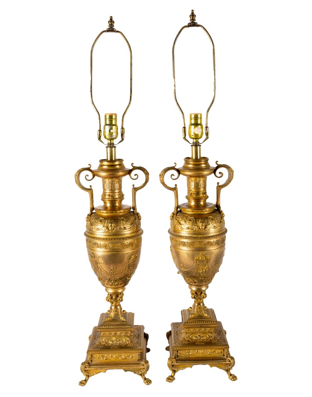 Appraisal: PAIR OF NEOCLASSICAL GILT-METAL URNSeach mounted as a table lamp