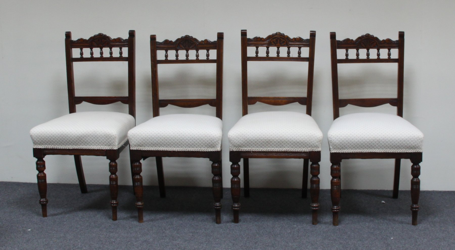 Appraisal: A set of four Edwardian dining chairs with carved crest