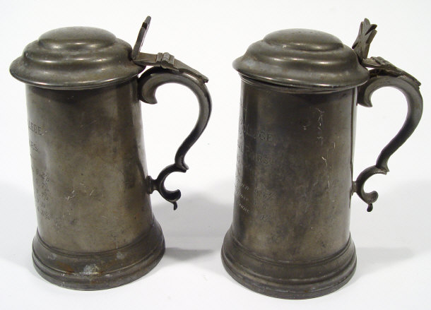 Appraisal: Two pewter tankards with hinged lids and glass bases the