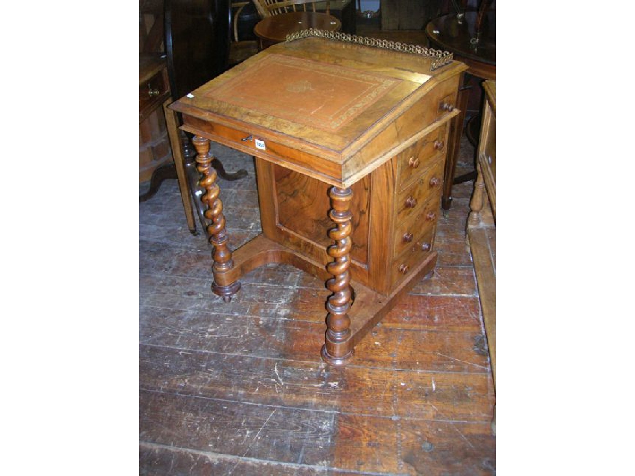 Appraisal: A Victorian figured walnut Davenport fitted with four real and