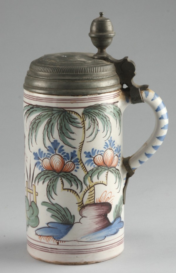 Appraisal: Tankard features landscape with woman standing in center handle with