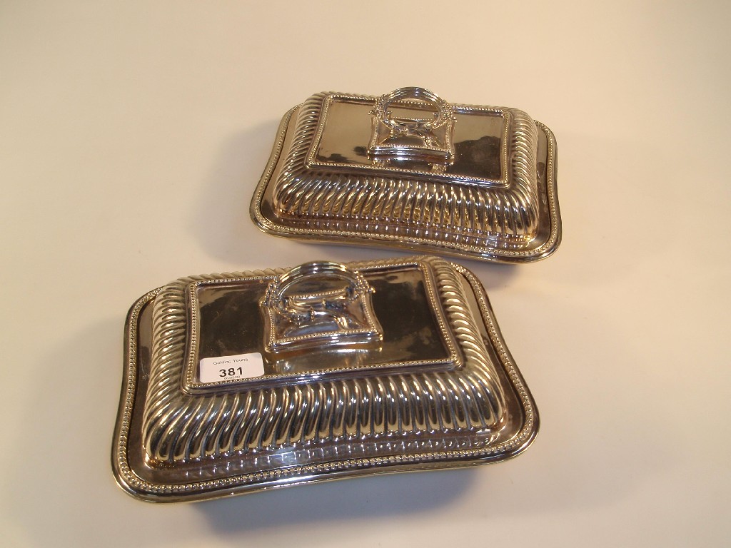 Appraisal: A pair of EPNS entre dishes and covers rectangular the