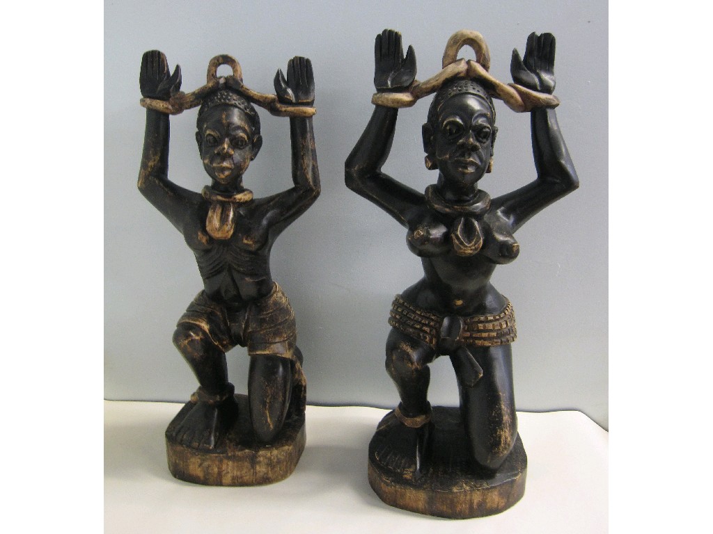 Appraisal: Pair of carved wood tribal figures