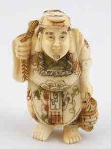 Appraisal: An Oriental bone carving of a fish seller approx cm