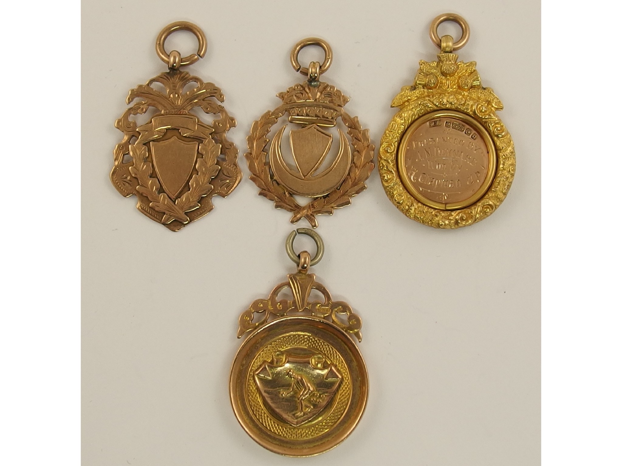 Appraisal: Four ct medallions one with a bowling theme and one