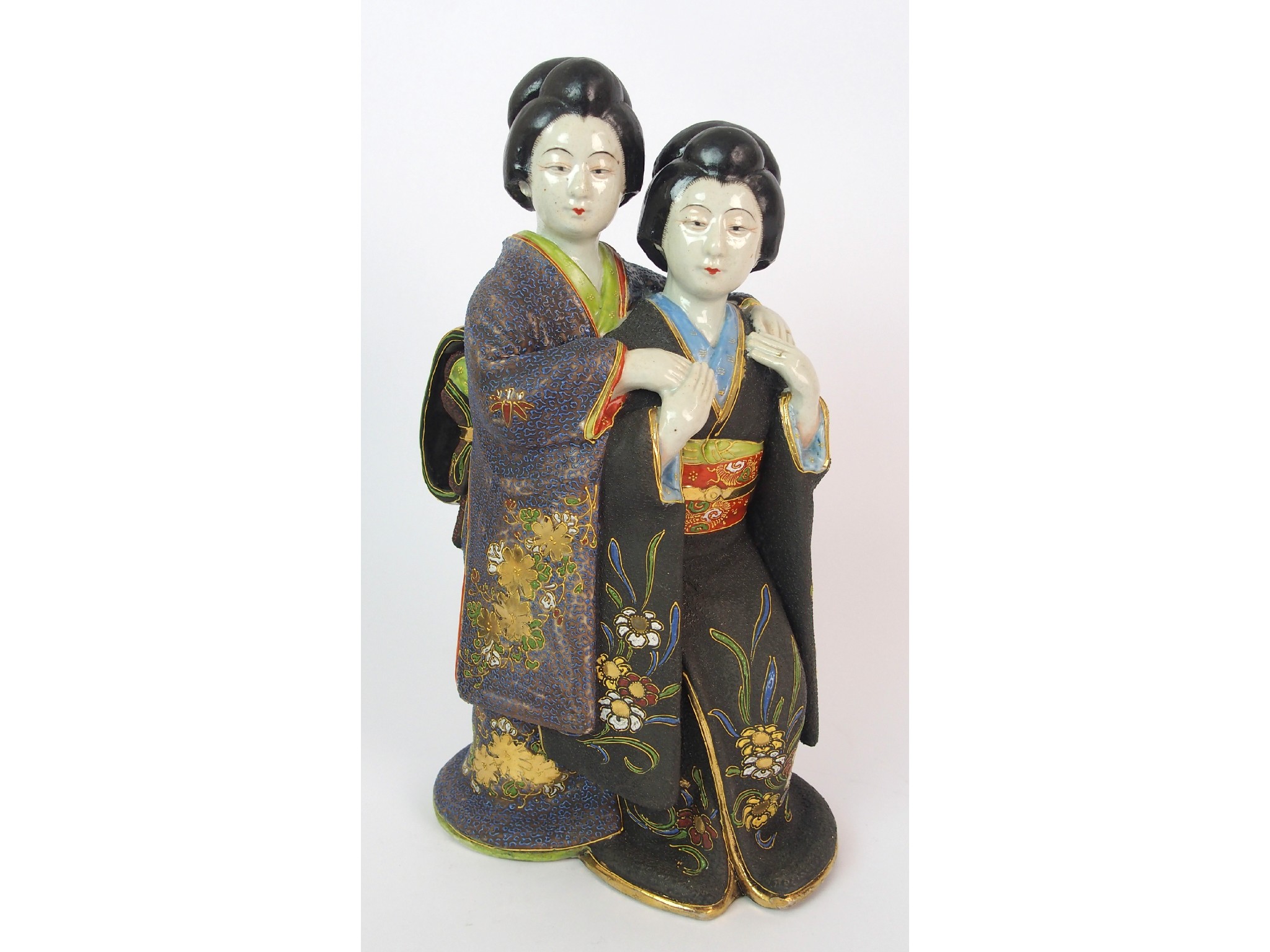 Appraisal: A Satsuma model of two ladiestogether holding hands painted in