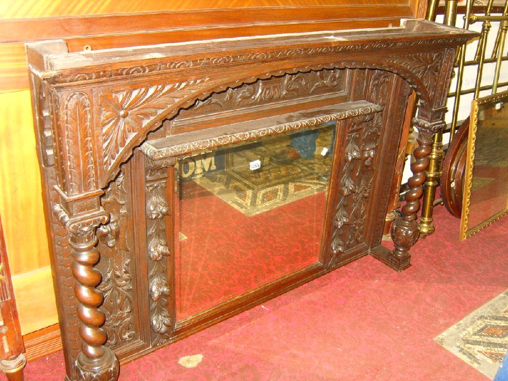 Appraisal: A Victorian Gothic dark oak overmantel sideboard back with carved