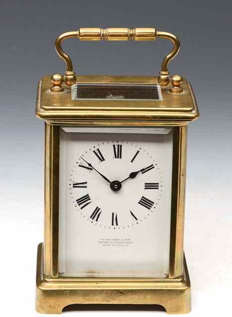 Appraisal: A FRENCH BRASS CARRIAGE TIMEPIECE with white enamel Roman dial