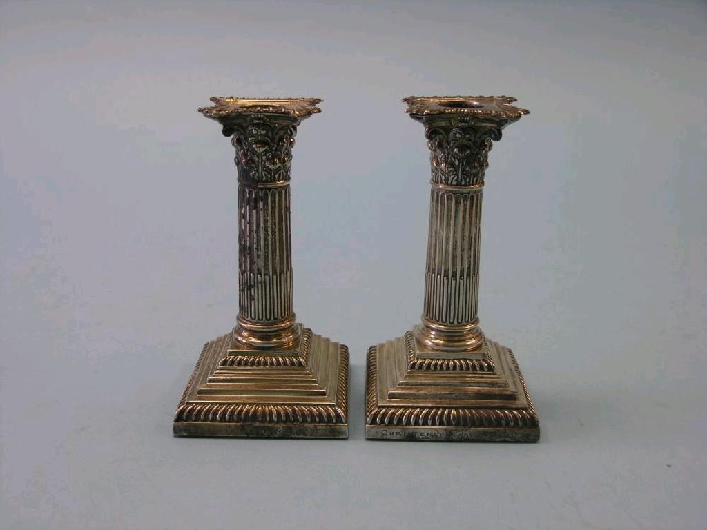 Appraisal: A pair of silver candlesticks corinthian column stems with detachable