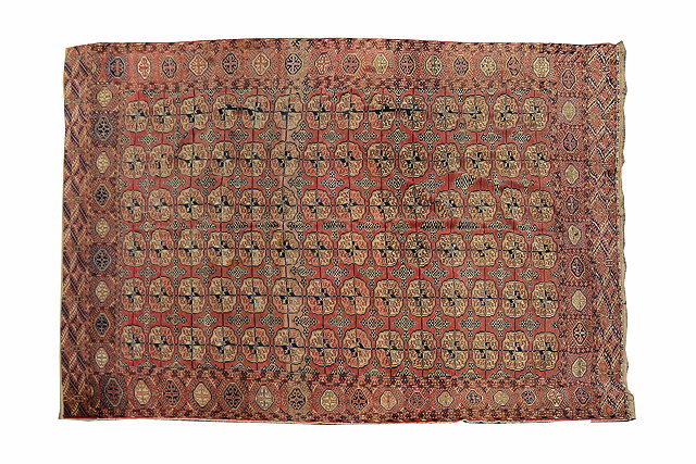 Appraisal: A TEKKE TURKOMAN BRICK RED GROUND MAIN CARPET with a