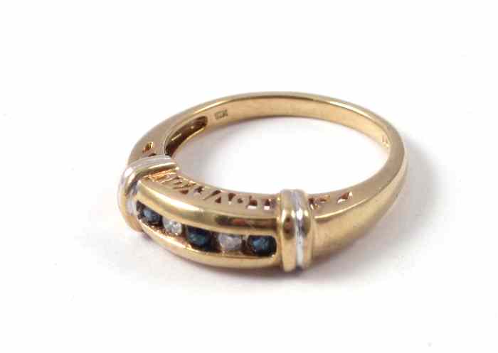 Appraisal: DIAMOND SAPPHIRE AND TEN KARAT GOLD RING featuring a channel