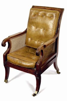 Appraisal: A George IV mahogany bergere the moulded frame with a