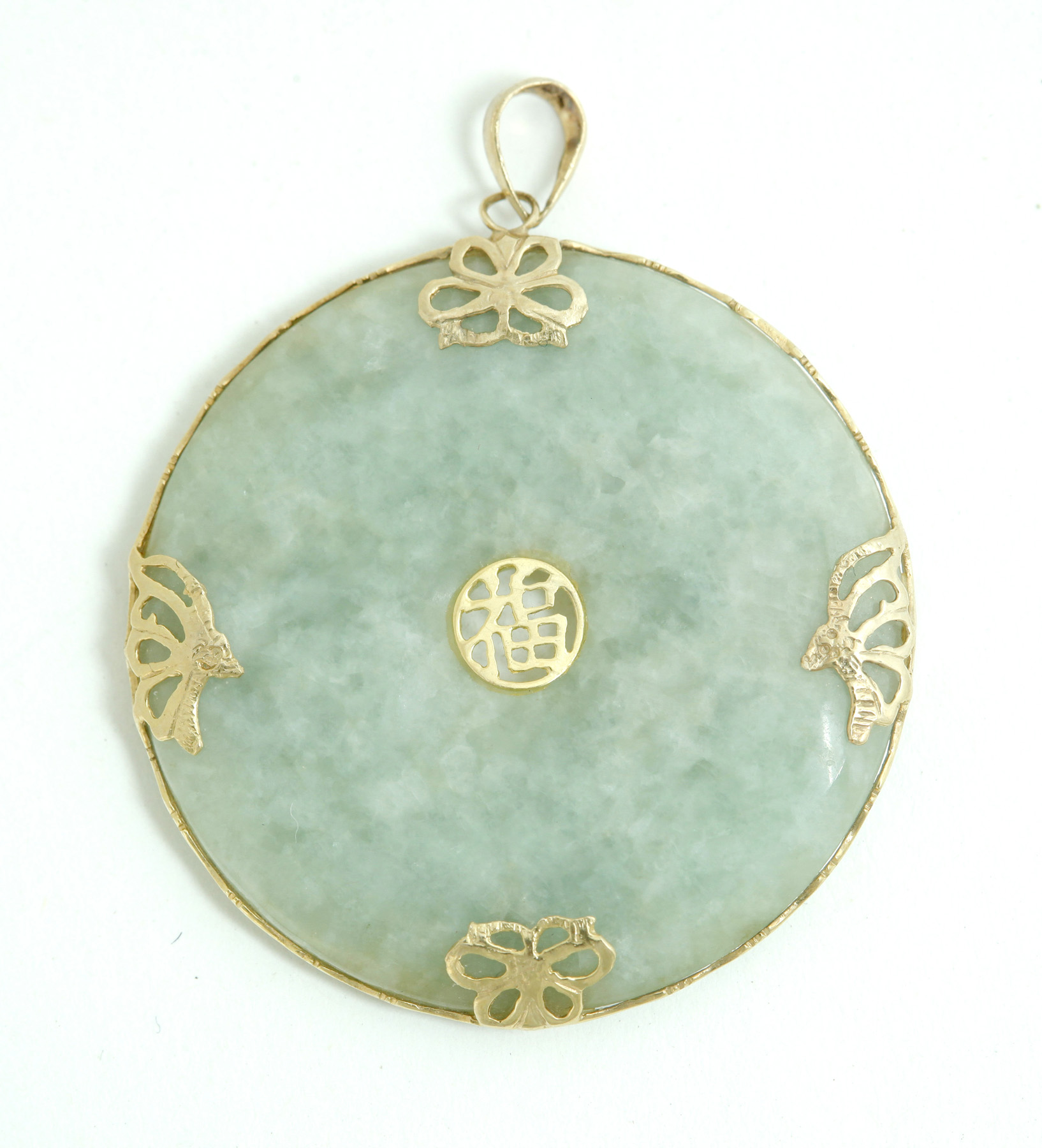 Appraisal: JADE PENDANT Asian th century k yellow gold mount containing