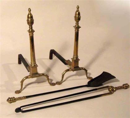 Appraisal: Brass andirons and fire tools The andirons with acorn finials