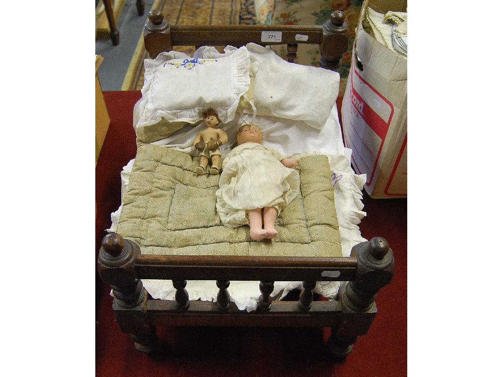 Appraisal: A dolls mahogany part Victorian bed with bedding to w