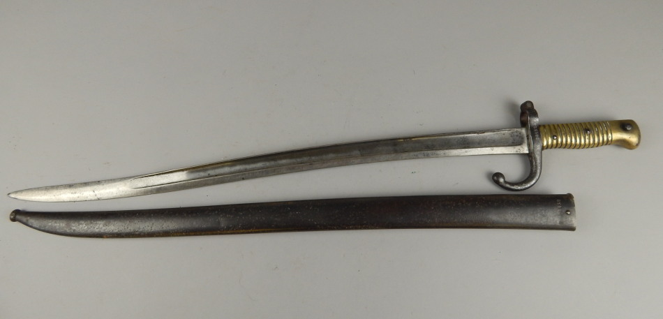 Appraisal: A thC French bayonet with brass handle metal scabbard dated