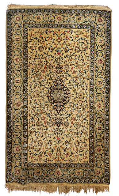 Appraisal: A KASHAN WHITE GROUND RUG with a central blue ground