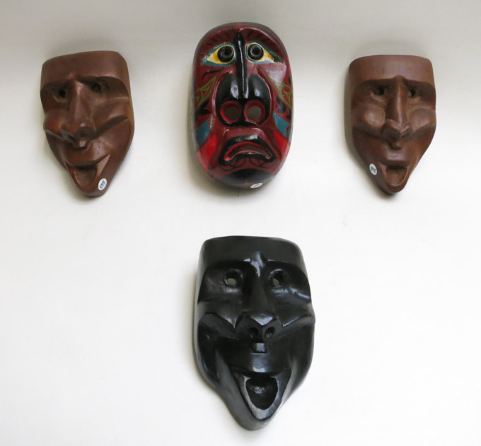 Appraisal: FOUR CARVED WOOD MASKS one polychrome painted mask one black