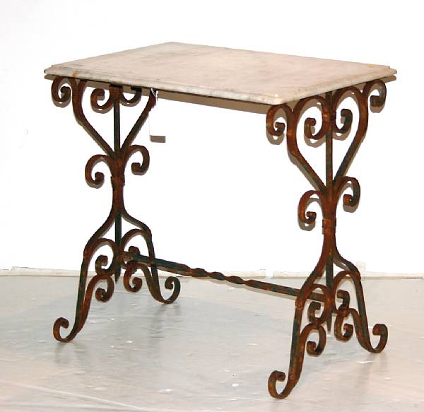 Appraisal: A pair of Rococo style wrought iron marble top tables