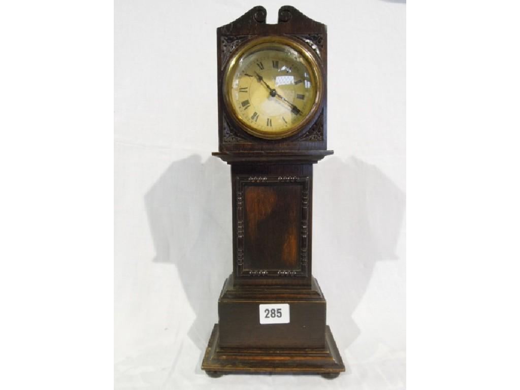 Appraisal: An oak cased mantle clock in the form of a