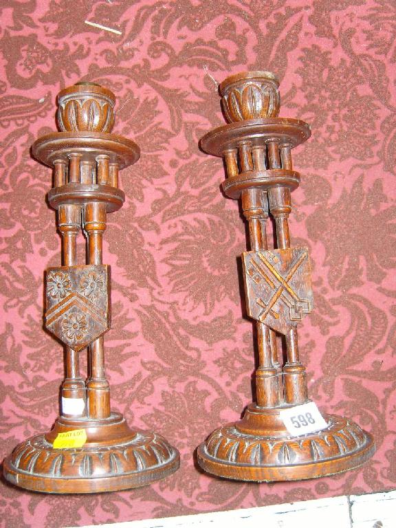 Appraisal: A pair of th century carved oak candlesticks with triple