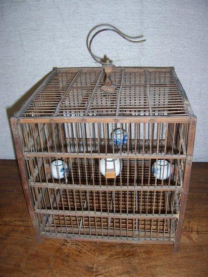 Appraisal: A Chinese bird cage with blue and white bird feeders