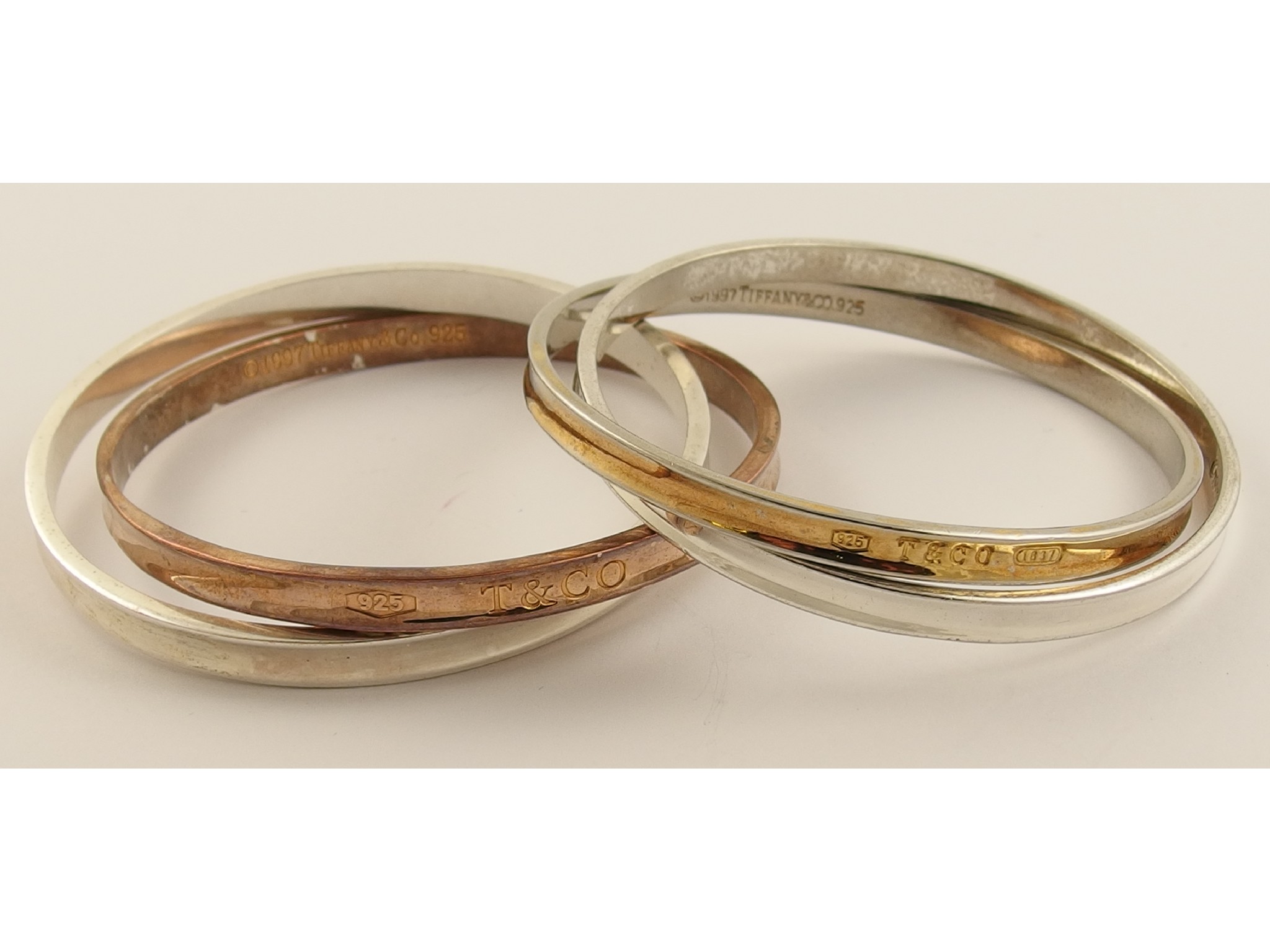 Appraisal: A set of two silver interlinked bangles stamped Tiffany Co