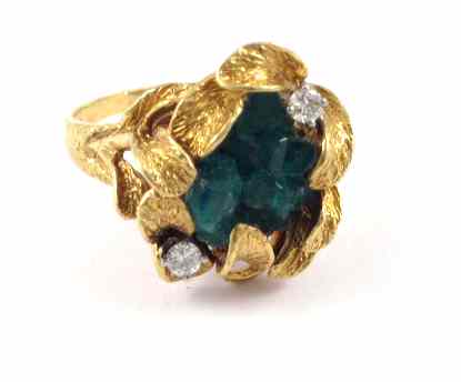 Appraisal: EMERALD AND EIGHTEEN KARAT GOLD RING Two round-cut diamonds are